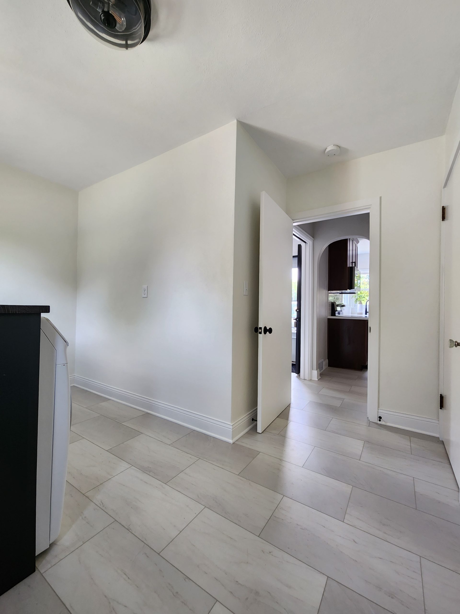 Black and white farmhouse style mudroom remodel with luxury vinyl tile flooring.