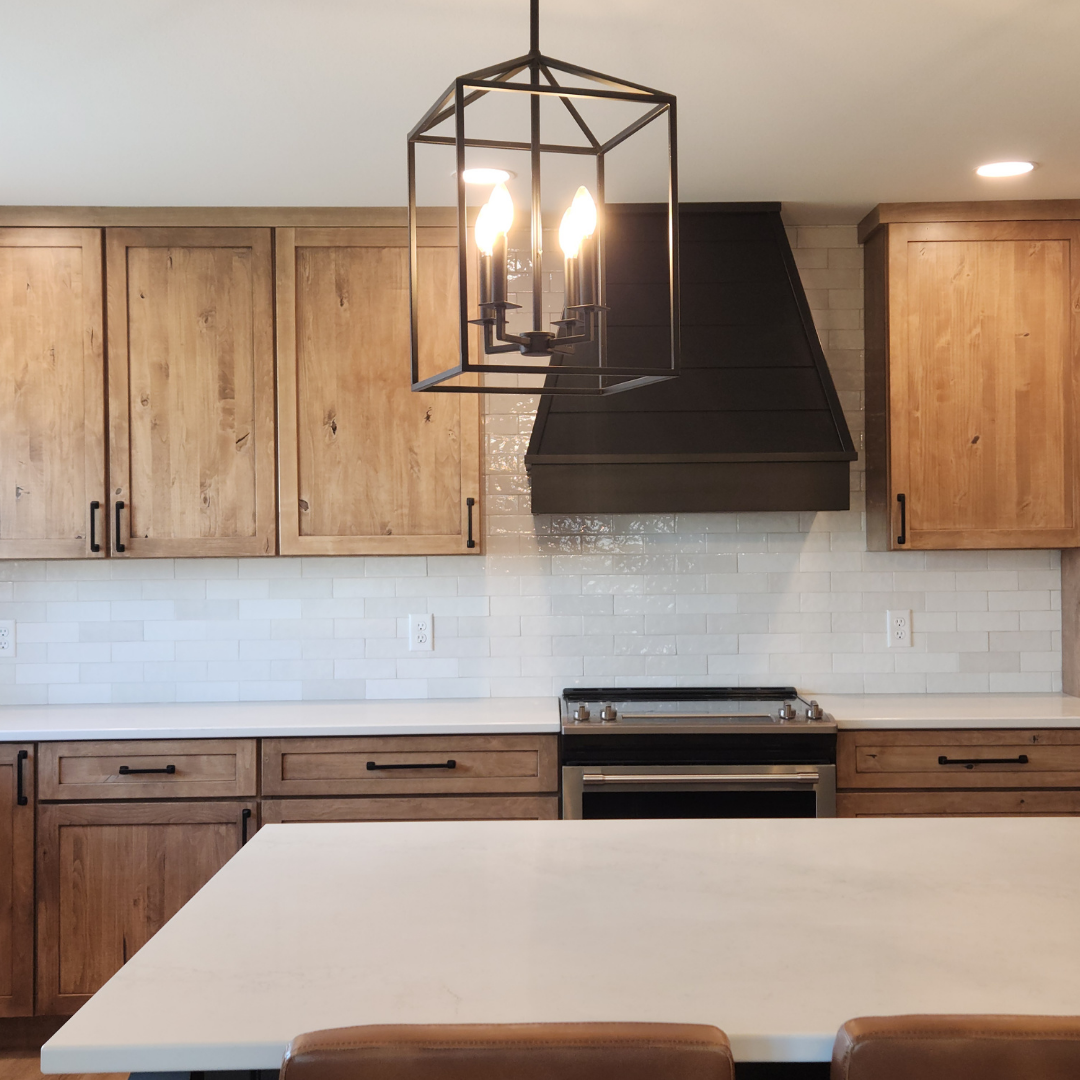 This picture showcases a beautifully designed and complete kitchen with the addition of a subway tile backsplash.