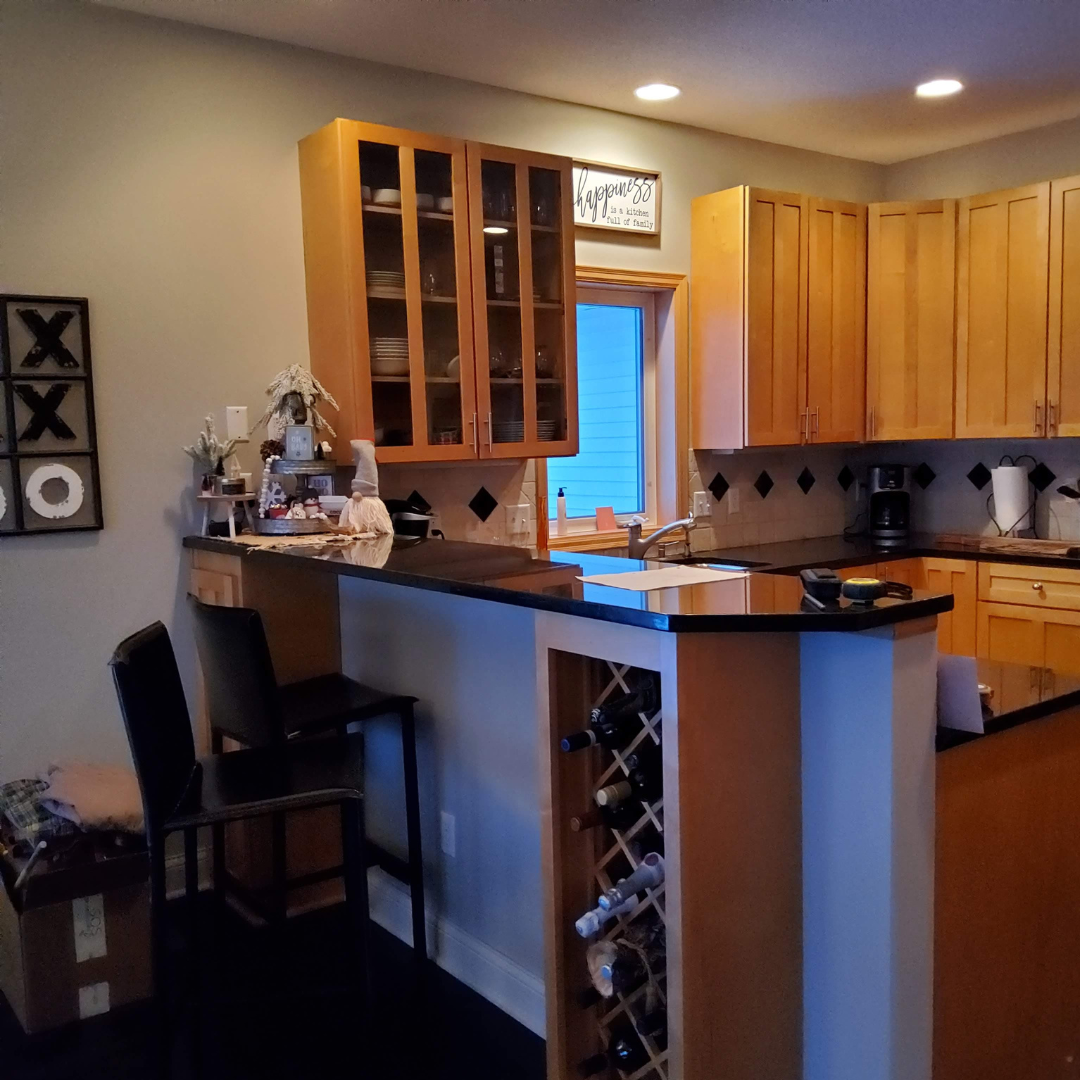 This picture highlights a kitchen ready for a new layout and refresh.  It presents a little dark, and could use brightening.  There is a peninsula that makes an L that could be changed. 