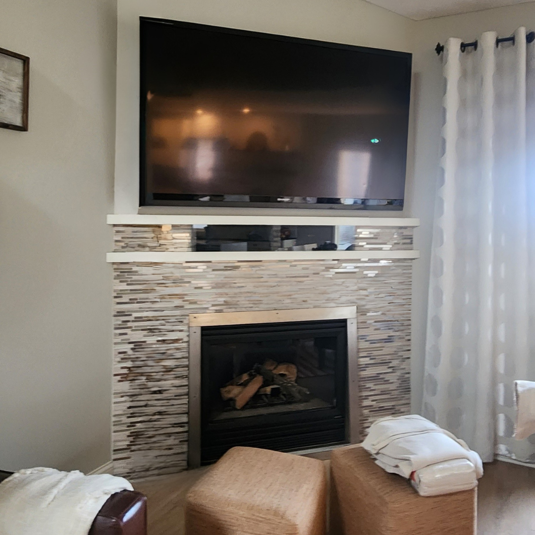This fireplace is functional but in need of a refresh especially to be cohesive with the rest of the updates happening in the home.  Currently, the surround has more of a mosaic tile look. 