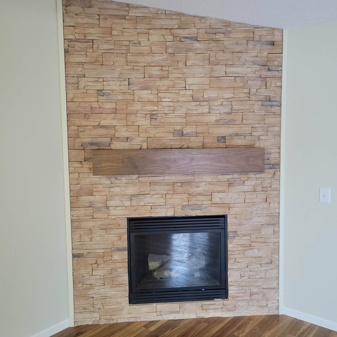 This fireplace went from having a more modern tile surround to a painted black brick with a natural wood mantle.  The look matches the rest of the finishes and color schemes of the home. 
