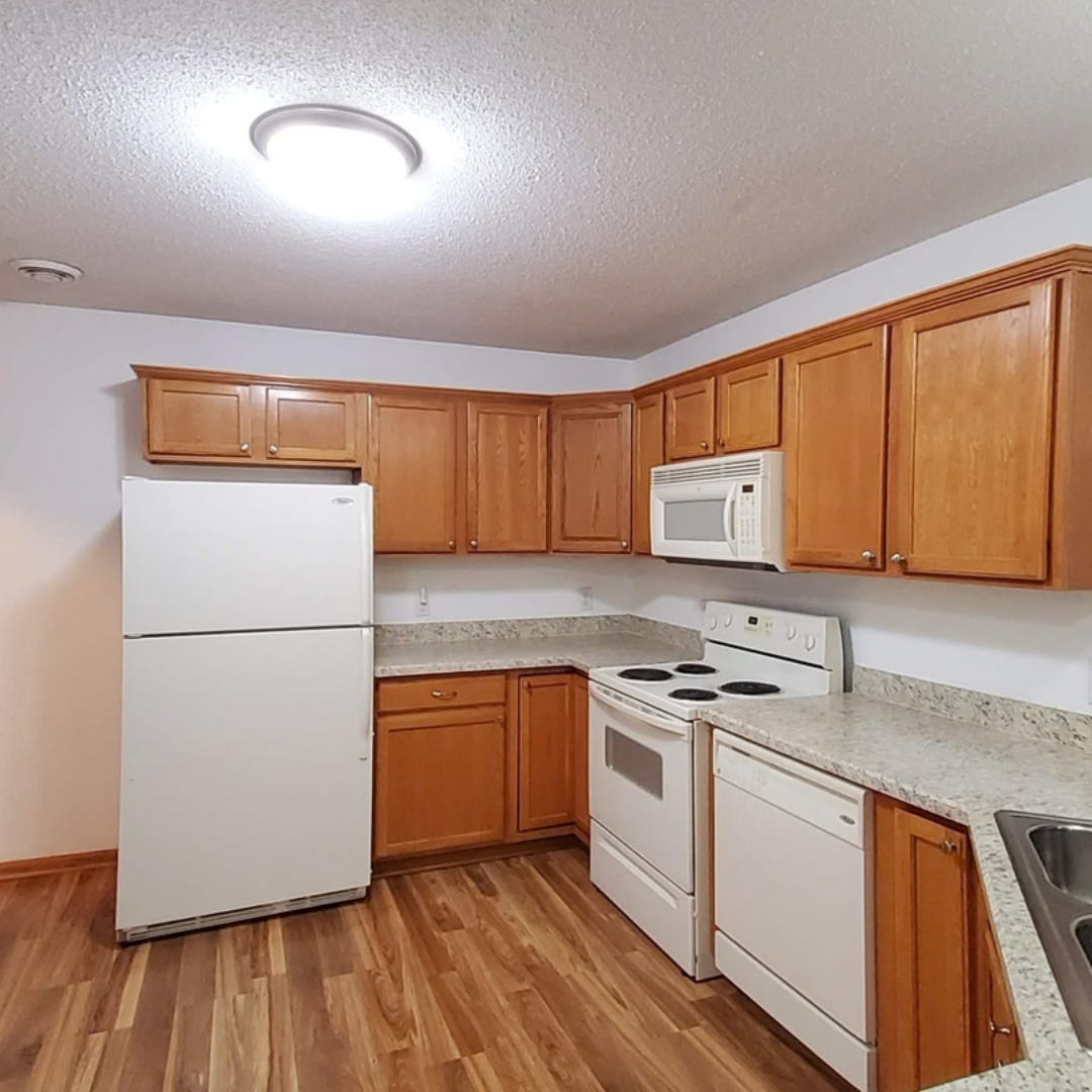 This picture highlights a kitchen ready for a new layout and refresh.  It presents a little dark, and could use brightening.  There is a peninsula that makes an L that could be changed. 