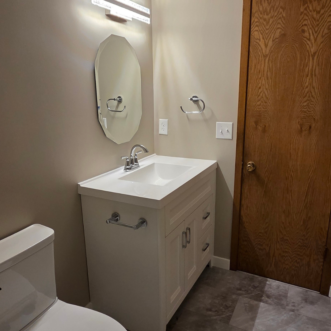 This fireplace went from having a more modern tile surround to a painted black brick with a natural wood mantle.  The look matches the rest of the finishes and color schemes of the home. 