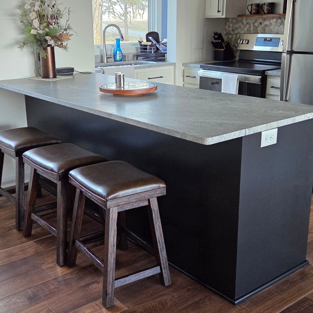 This fireplace went from having a more modern tile surround to a painted black brick with a natural wood mantle.  The look matches the rest of the finishes and color schemes of the home. 