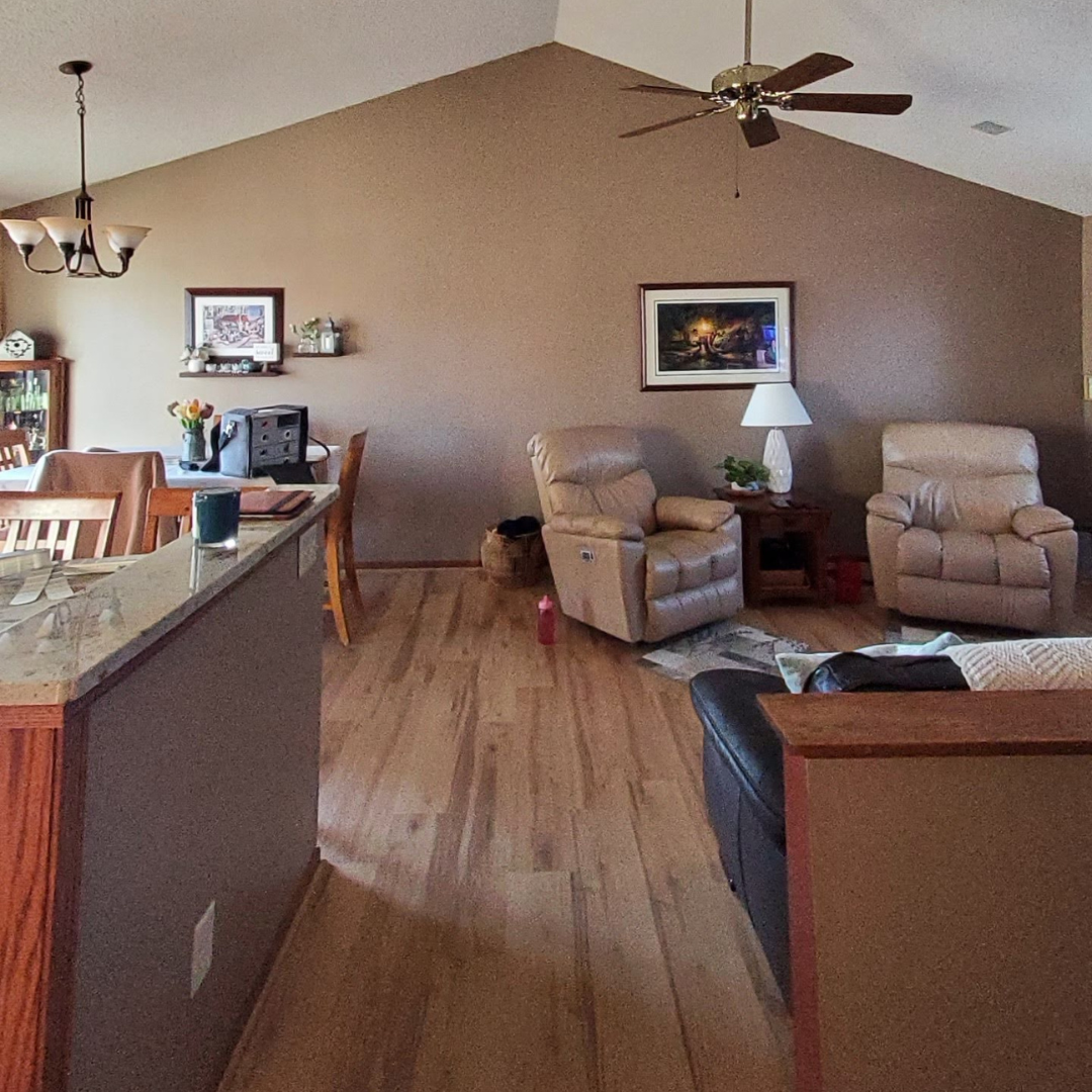 This picture highlights a kitchen ready for a new layout and refresh. It presents a little dark, and could use brightening. There is a peninsula that makes an L that could be changed. 