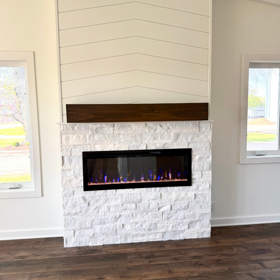 This fireplace went from having a more modern tile surround to a painted black brick with a natural wood mantle. The look matches the rest of the finishes and color schemes of the home. 