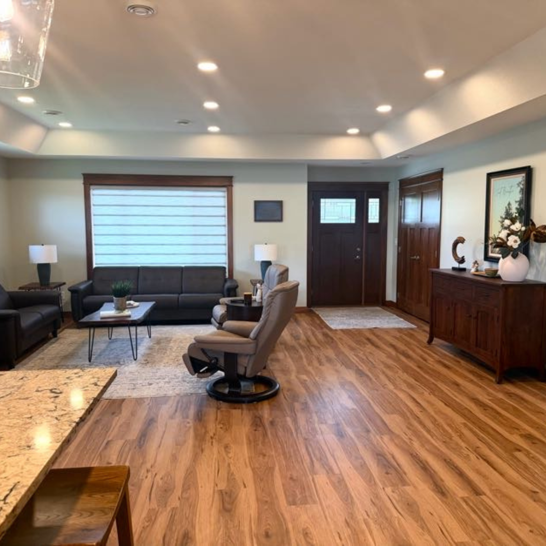 This fireplace went from having a more modern tile surround to a painted black brick with a natural wood mantle. The look matches the rest of the finishes and color schemes of the home. 